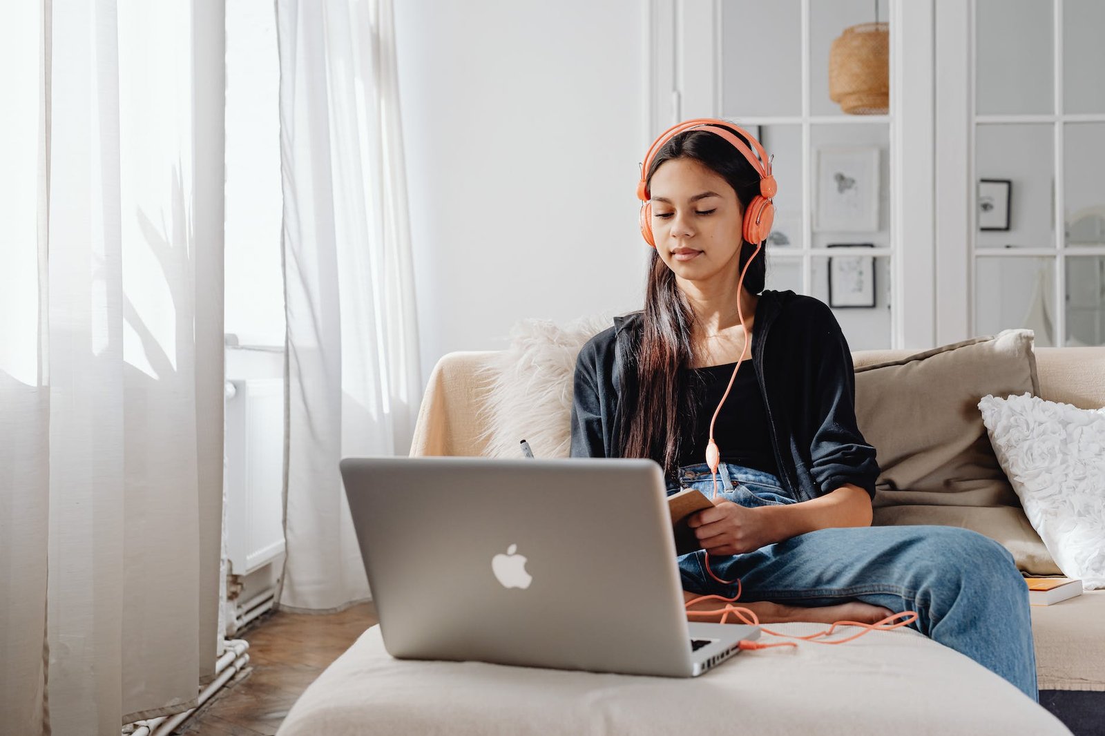 woman using a laptop with headphones